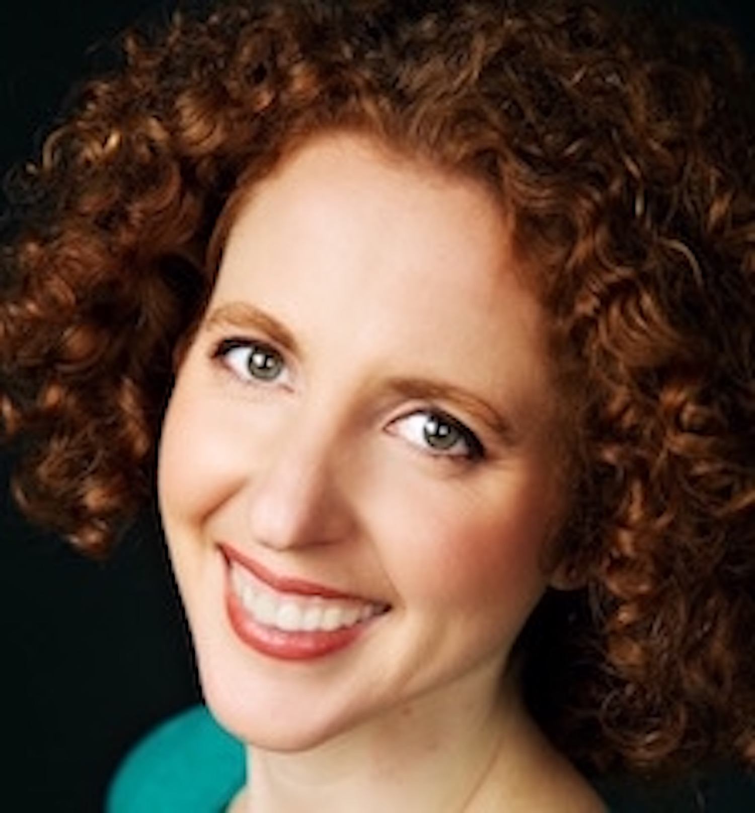 Carolyn Arnold smiling, wearing a teal top